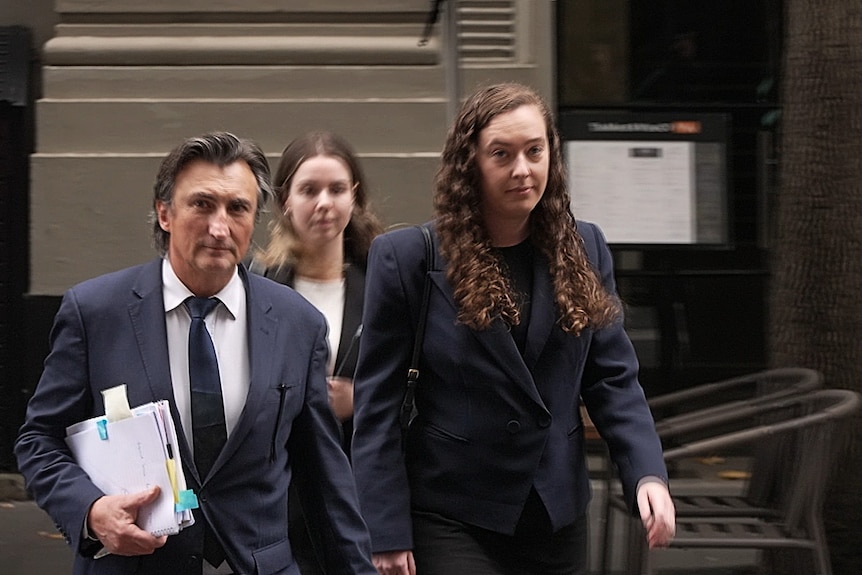 Woman walking alongside lawyer