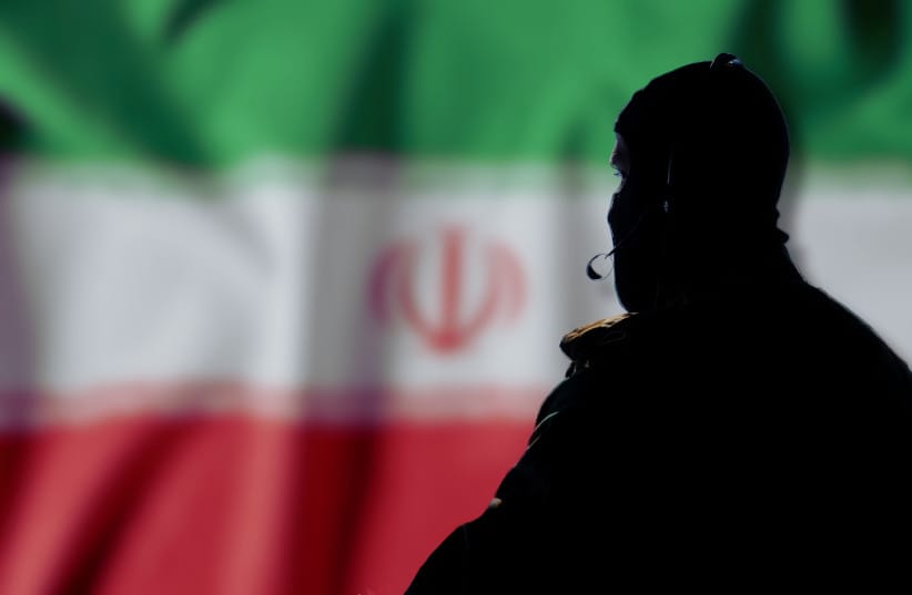 An illustrative image of an Iranian agent in the backdrop of an Iranian flag.
