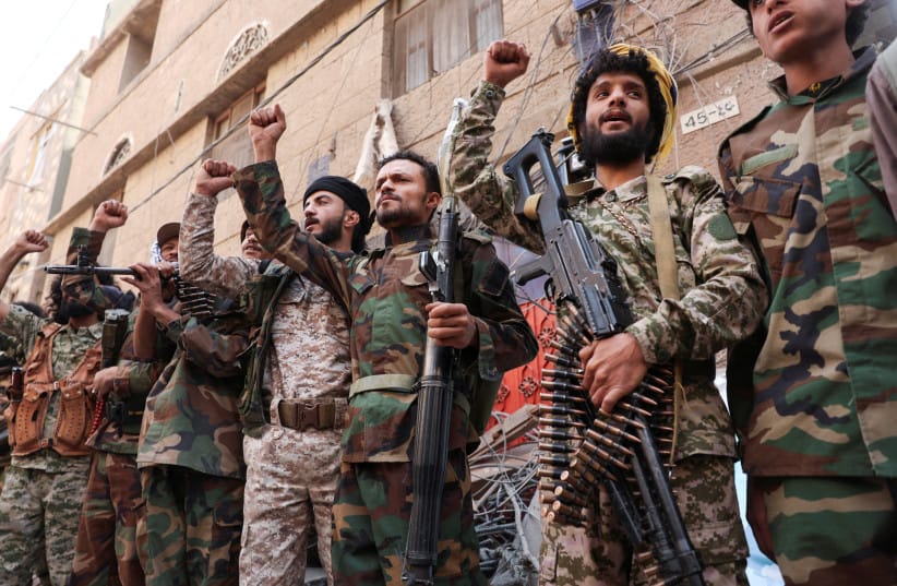 HOUTHI TERRORISTS carry weapons as they stand near the site of Israeli airstrikes in Sanaa, Yemen, in September. Iran has reportedly lost control of the Houthis, the writer notes.