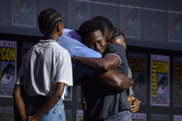 “Black Panther” star Letitia Wright (left) looks on as Winston Duke (center) and Jonsson (right) embrace during a Marvel Studios panel at San Diego Comic-Con on Saturday.