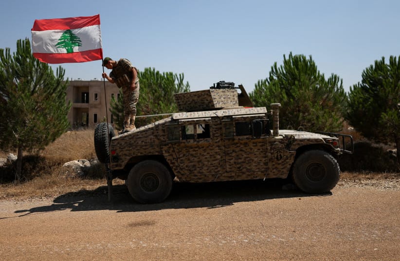 A soldier adjusts a Lebanese flag on an armored vehicle in Zawtar al-Gharbiyeh village, southern Lebanon, as Lebanese soldiers deploy in the area, July 21, 2026