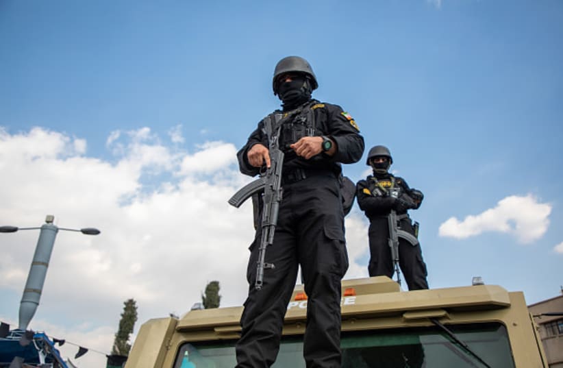 (FILE PHOTO) Members of security forces look on during a funeral procession held for IRGC Navy Chief Alireza Tangsiri, alongside other senior naval commanders and their families who were killed in US-Israeli strikes in late March, on April 1, 2026 in Tehran, Iran.