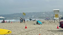 High surf and stronger rip currents continued over the weekend at Mission Beach, where many people went for relief from the heat, July 26, 2026.