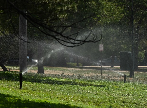Sprinklers run at 1 p.m. in a median near Auraria Parkway and Speer Boulevard despite drought-related water restrictions on Tuesday, July 21, 2026, in Denver. (Photo by RJ Sangosti/The Denver Post)