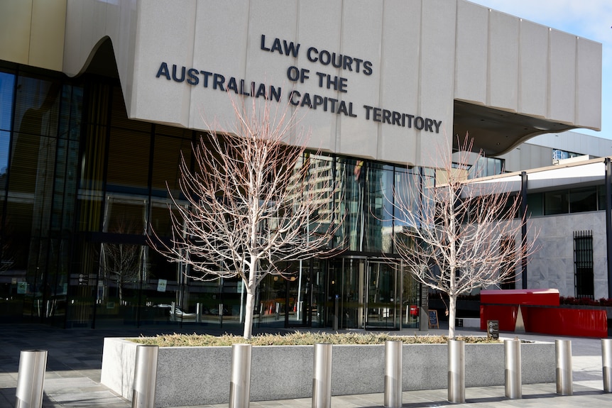 The exterior of a concrete building that reads "Law Courts of the Australian Capital Territory" over the entrance.