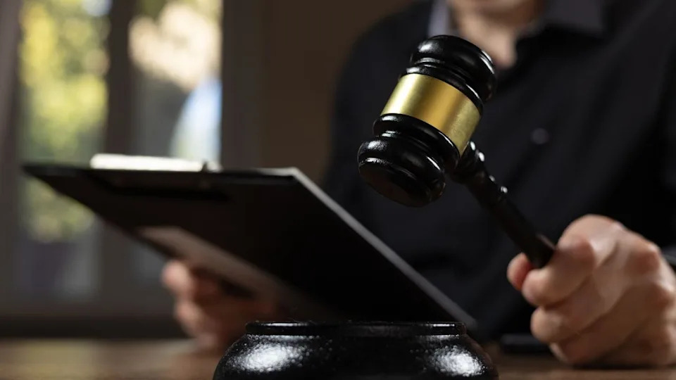 Judge with paper document pronouncing sentence
