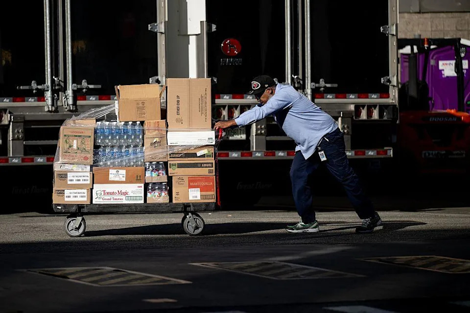 A worker pushes pallets of water bottles and other items into Madison Square Garden on Thursday.
