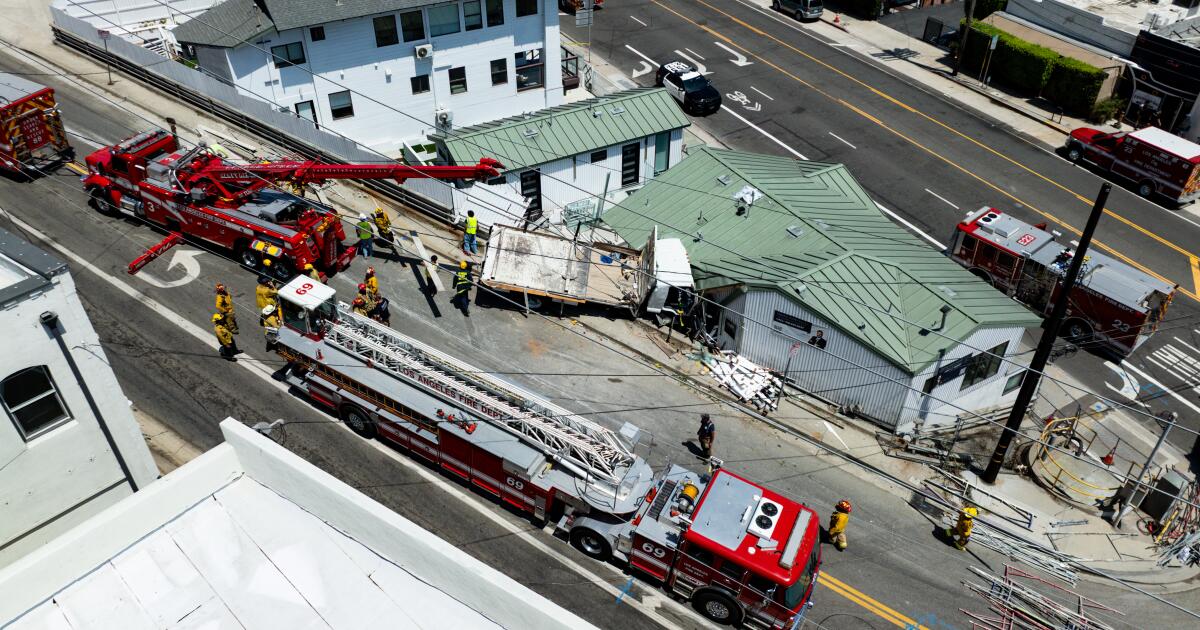 L.A. Fire rescue a man trapped in a truck that crashed into a building