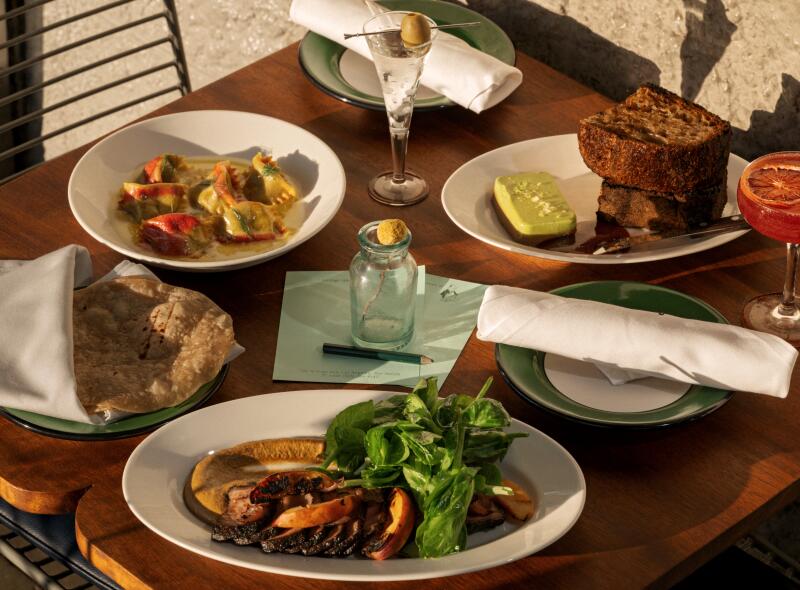  A spread of popular dishes including grilled pork with tortillas at Sqirl in Los Angeles.