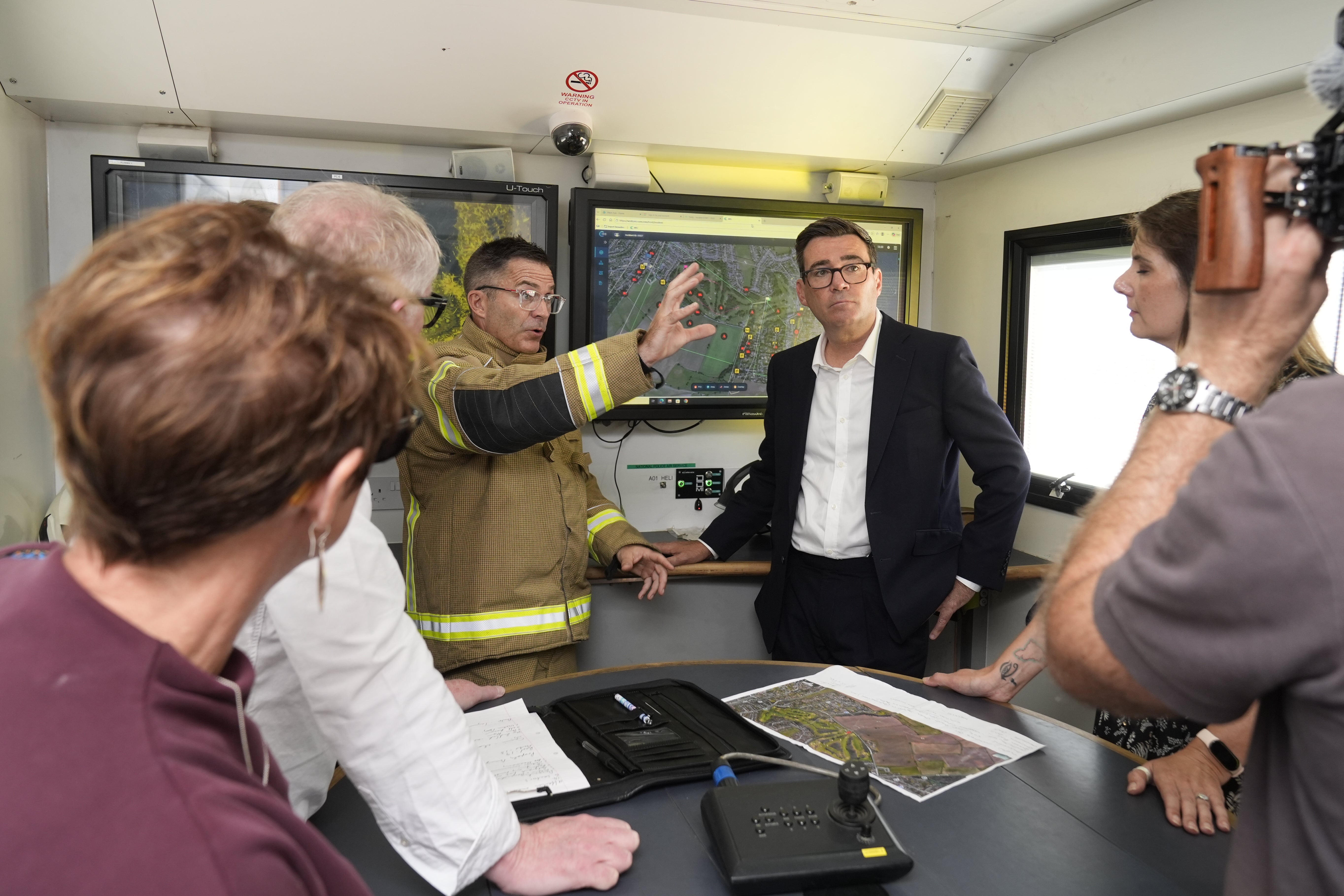 Prime Minister Andy Burnham speak to emergency responders at the West Midlands Fire Service incident command unit during a visit to Stourbridge in the West Midlands