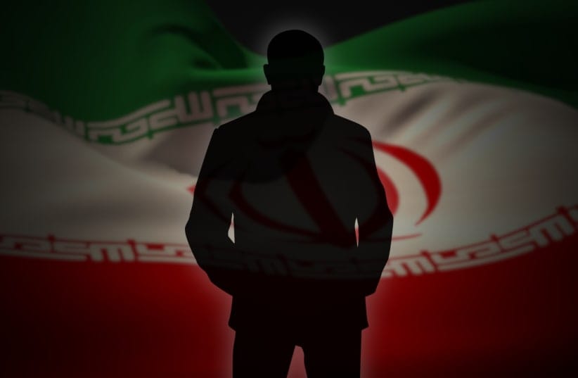  The silhouette of a person, with Iran's flag in the background (illustrative). 