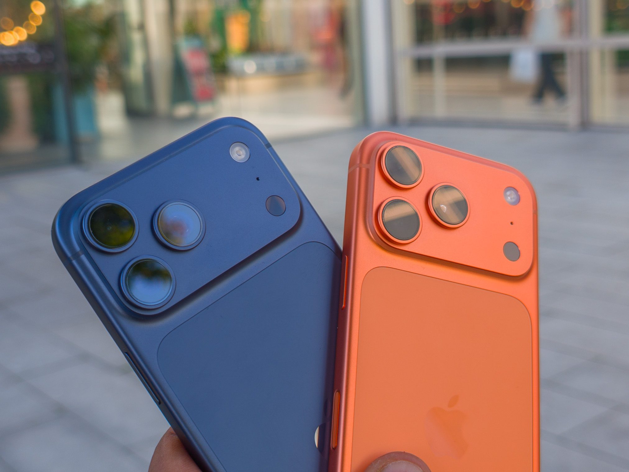 Apple iPhone 17 Pro in Cosmic Orange next to the iPhone 17 Pro Max in Deep Blue