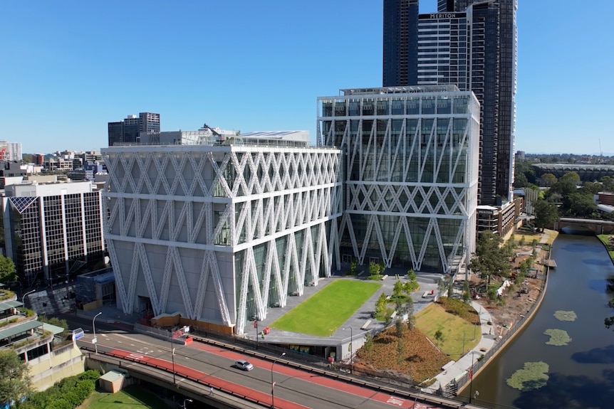 a two-tower building on the bank of a river