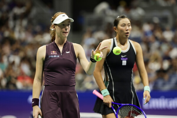 Maya Joint, left of Australia, reaches for a ball as she plays a women's doubles match with partner Hao-Ching Chan, of Taiwan, against Venus Williams and Serena Williams, of the United States at the U.S. Open tennis championships, Friday, Sept. 4, 2026, in New York. (AP Photo/Adam Hunger)