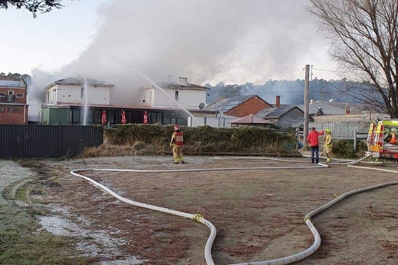 A building with smoke, destroyed by fire.