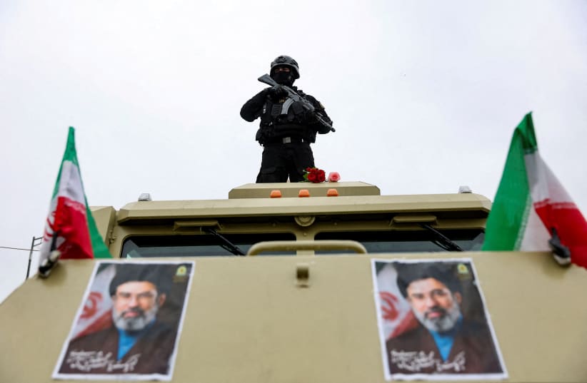 A security personnel stands guard as Iranians take part in a protest marking the annual al-Quds Day, on the last Friday of the holy month of Ramadan, in Tehran, Iran, March 13, 2026