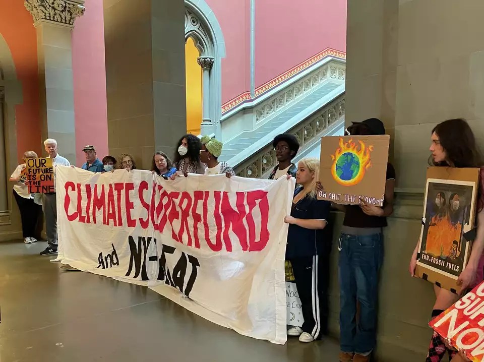 A group of students protest with a sign