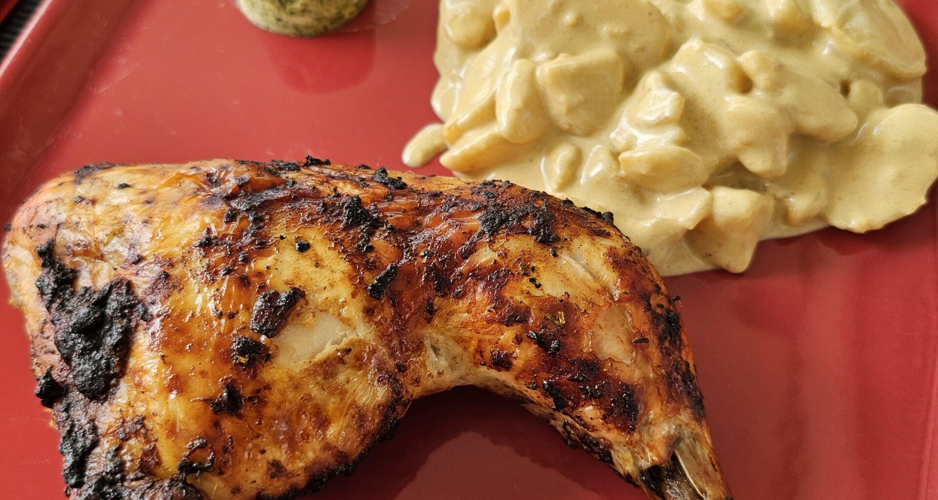 Grilled chicken thighs with freshly made potato salad and herb butter