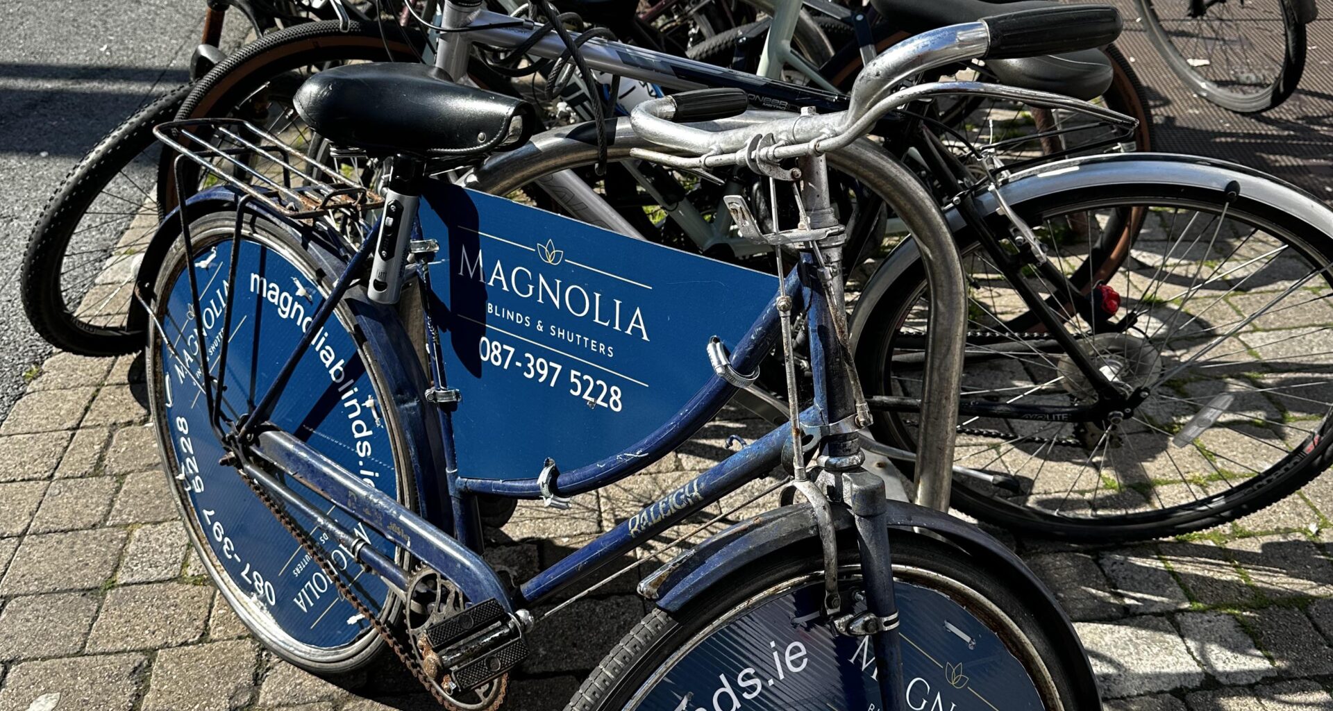 Hate this new advertising trend: Broken, rusty bike on already crowded racks