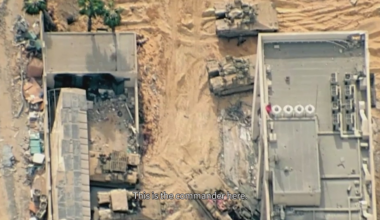 IDF Chief of Staff Herzi Halevi flies overhead while Israeli soldiers below wave flag