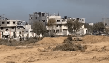 Gaza residents from Zaytun neighborhood walking south through the humanitarian corridor established by the IDF, notice the tanks keeping them safe, while some Gazan some of the people holding white flags.