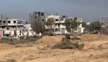 Gazans going south along Salah Al Din with IDF tank guarding.