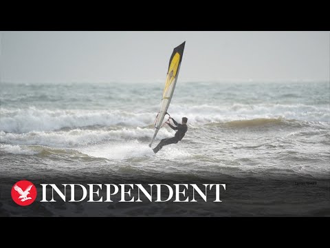 People kite and windsurf on Avon Beach as Storm Gerrit hits UK