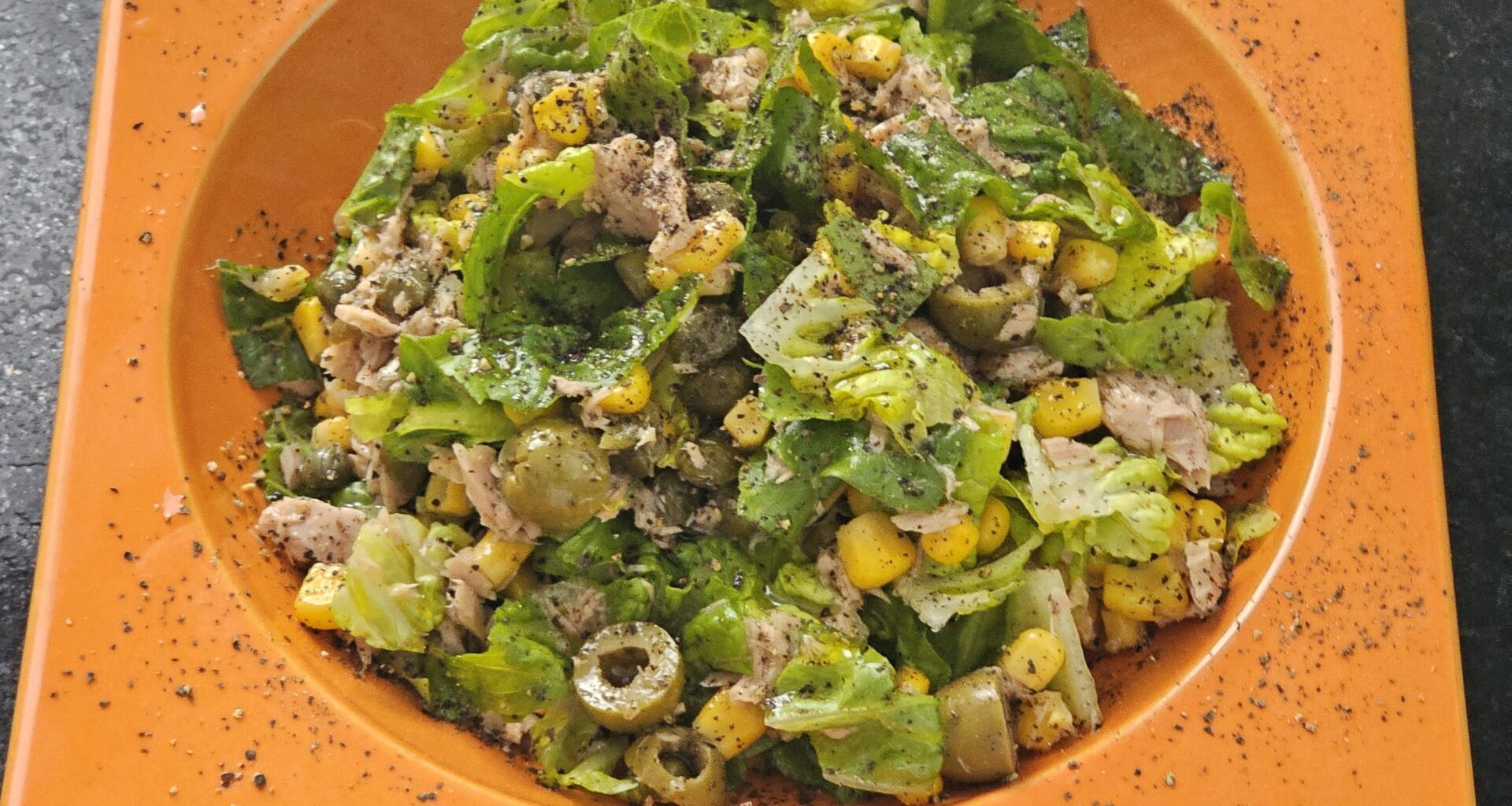 Romaine lettuce with tuna, sweetcorn, olives, capers, olive oil and freshly ground black pepper