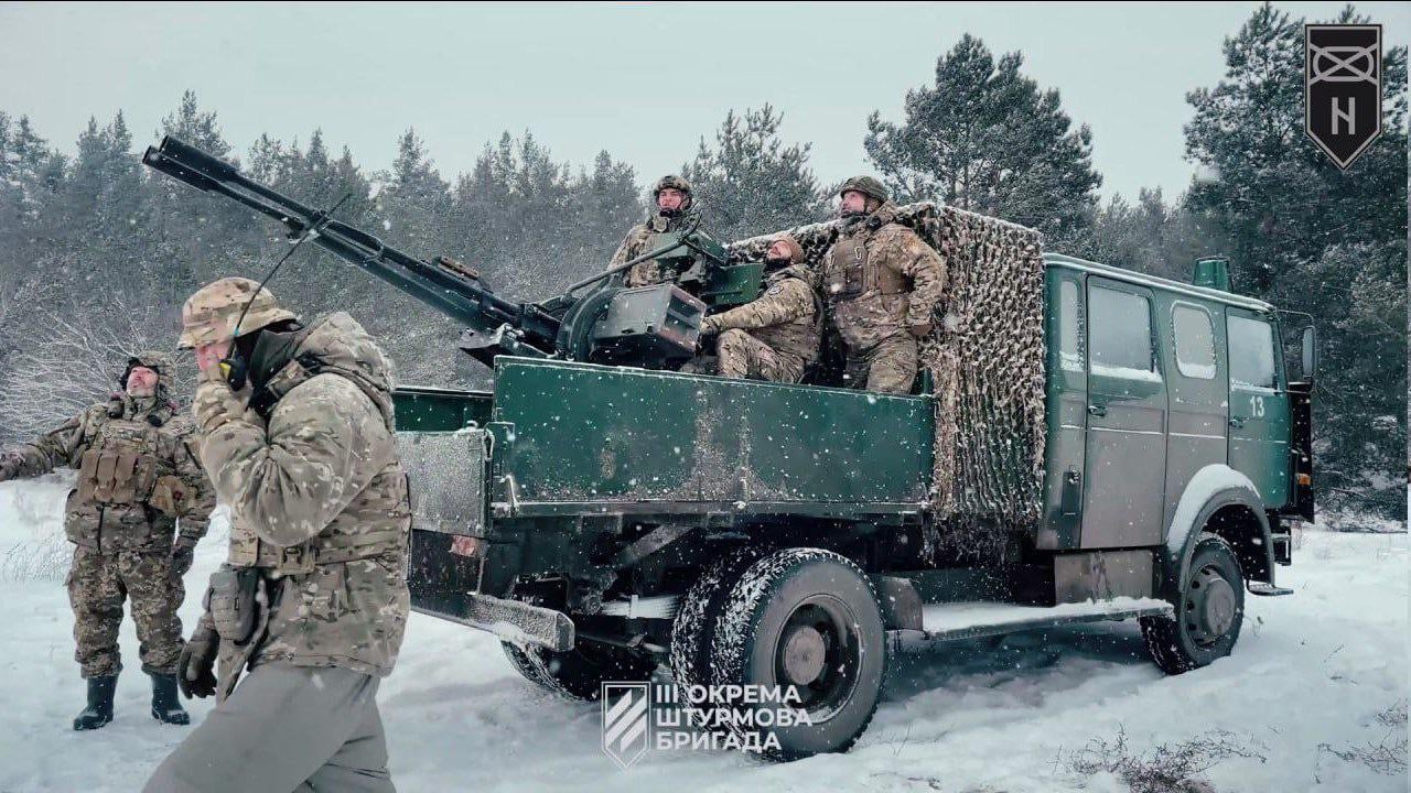 'Iveco-Magirus 120-23' truck, with a ZU-23-2 anti-aircraft twin-barreled autocannon, of the Ukrainian Army on a snowy field near a forest – January 2024