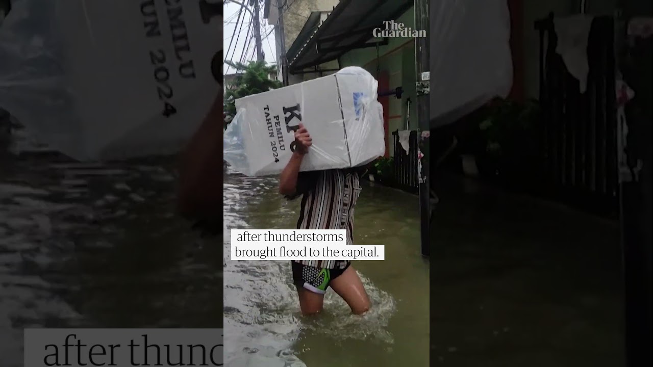 Ballot boxes carried over knee-high floodwater in Jakarta as Indonesia went to the polls