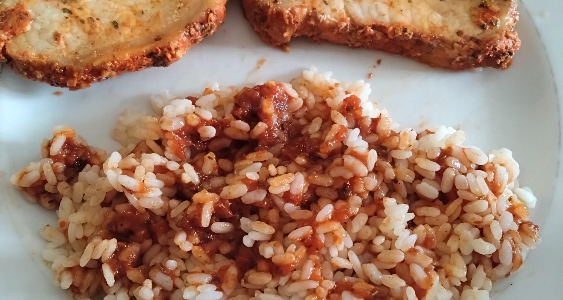 Lomo adobado with rice and black garlic tomato sauce