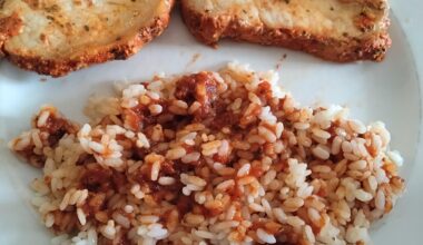 Lomo adobado with rice and black garlic tomato sauce