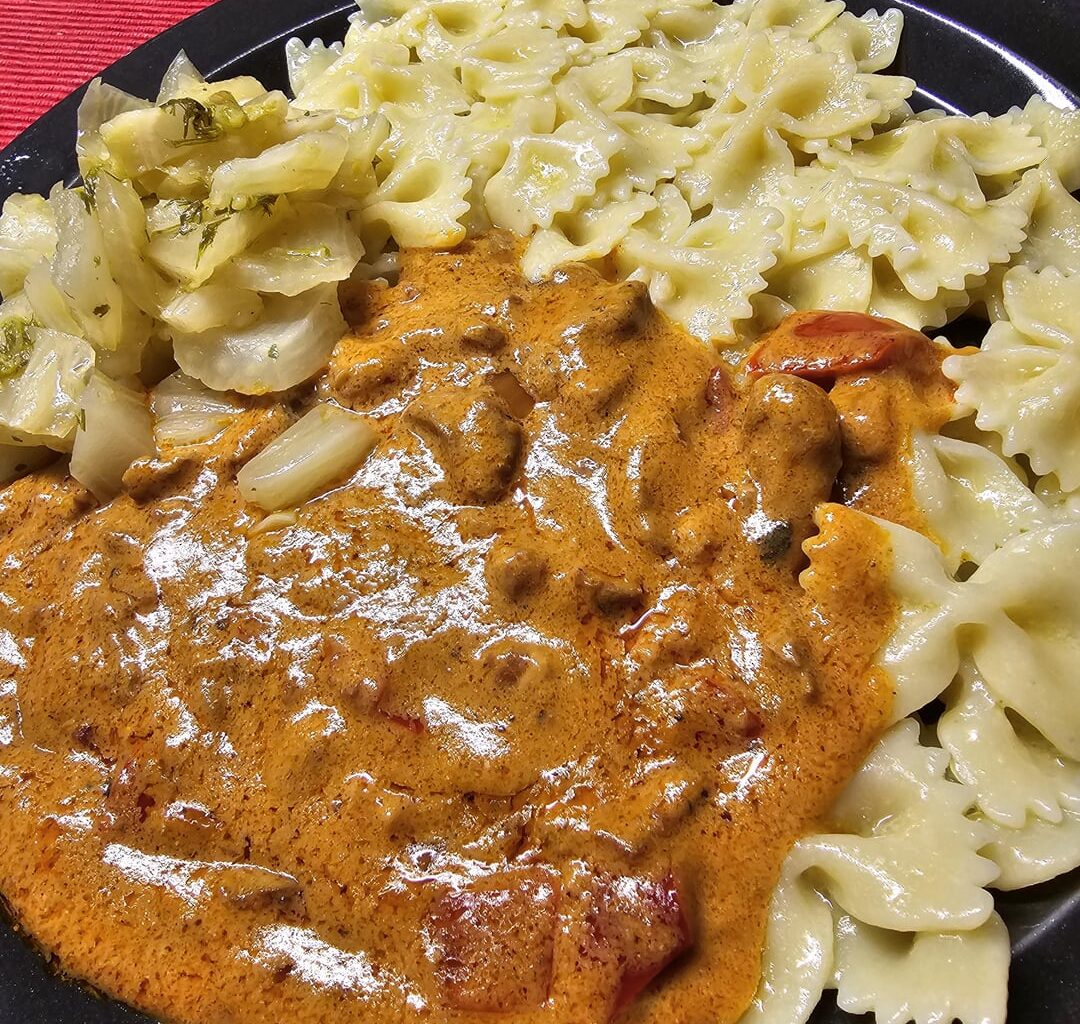 Sliced pork in a creamy sauce, with farfalle pasta and fennel steamed in lemon juice and olive oil