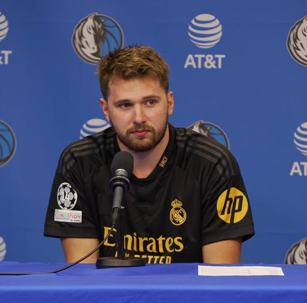 Luka Doncic wearing RM jersey on a press conference