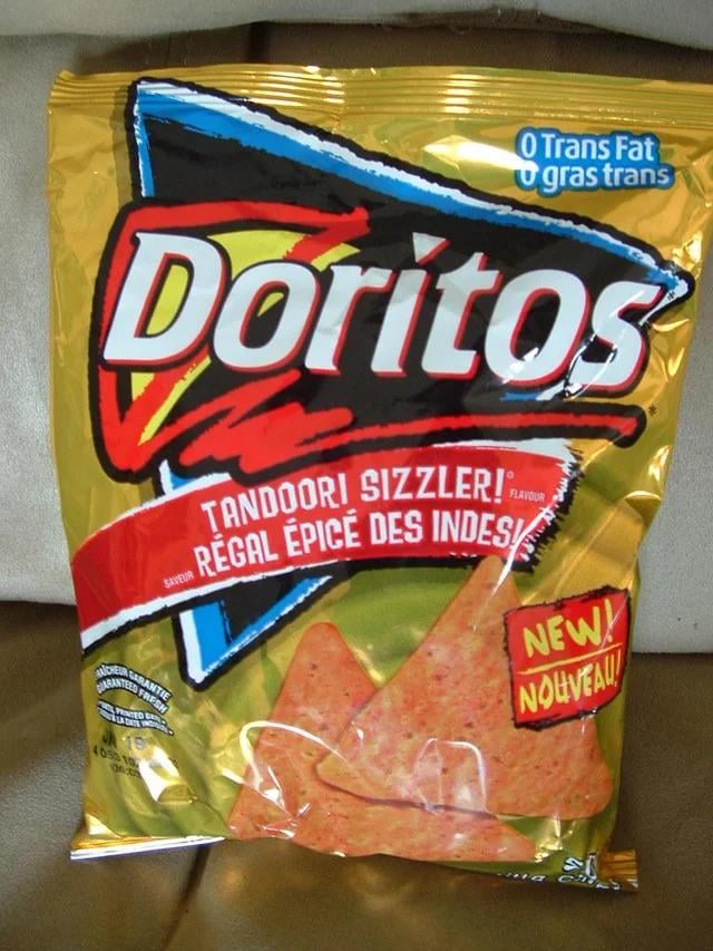 Anyone else remember this tandoori sizzler flavour Doritos that used to exist in the UK in the 2000s? Although I seem to recall it coming in a purple packaging yet I can’t find any image of that. Anyone else recall that too?