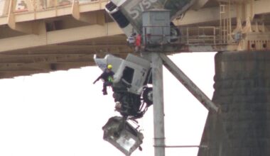 Firefighter abseils to rescue driver of truck hanging off bridge in Kentucky