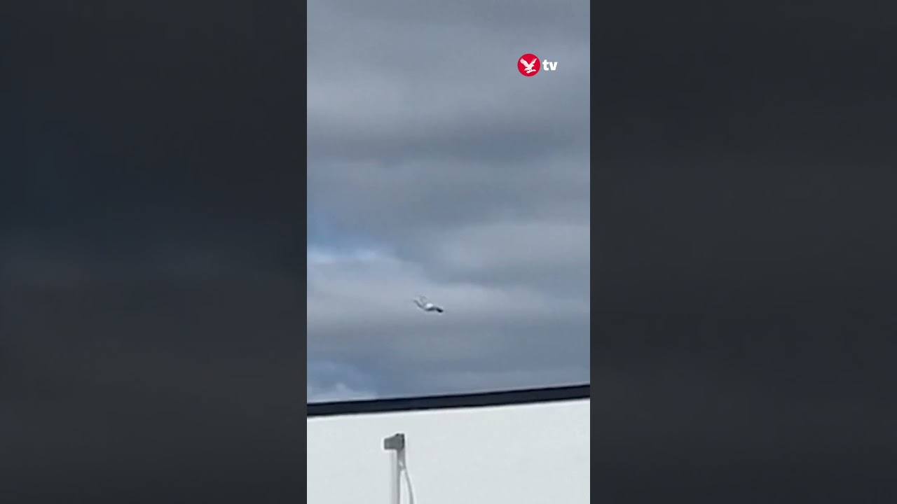 Burning Russian military plane flies over houses #shorts