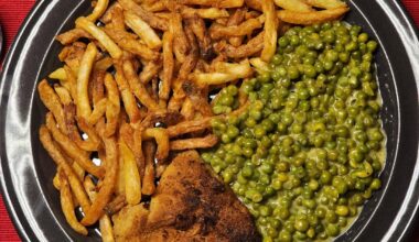 Homemade breaded schnitzel and fries, with creamy caramelised peas (and some of us can't do without tomato sauce for their fries ;)