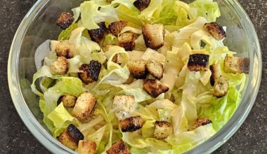 Simple salad with olive oil, ground pepper and freshly prepared croutons