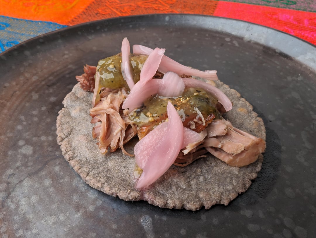 Homemade blue corn tacos with turkey, salsa verde and pickled red onions.