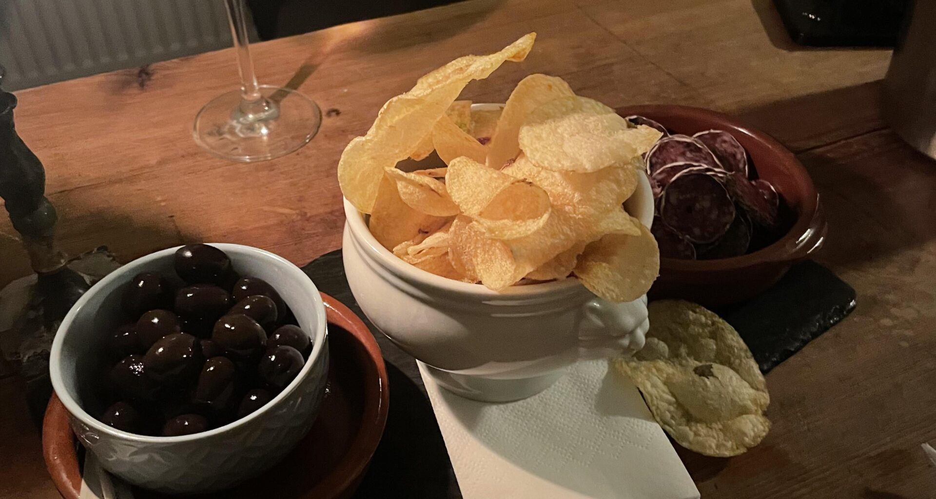 Wine bar tapas - Olives, chips, and saucisson