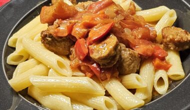 Penne with meatballs made from coarse pork sausage in a creamy red wine sauce with onions, paprika, and peppers
