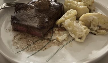 Strip steak, pommes au gratin and black garlic butter.