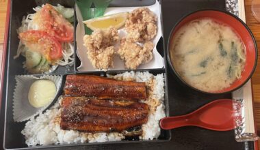 Grilled eel bento with fried chicken, miso soup, and salad in Berlin