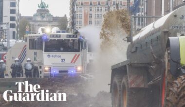 Belgian farmers spray manure towards police who respond with water cannon