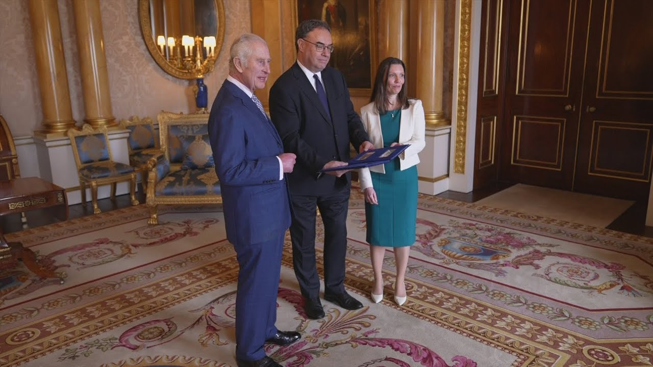 The King is presented with bank notes featuring his portrait