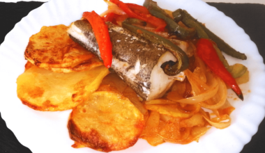 Sliced Potatoes, Fish and Vegetables Cooked In The Oven