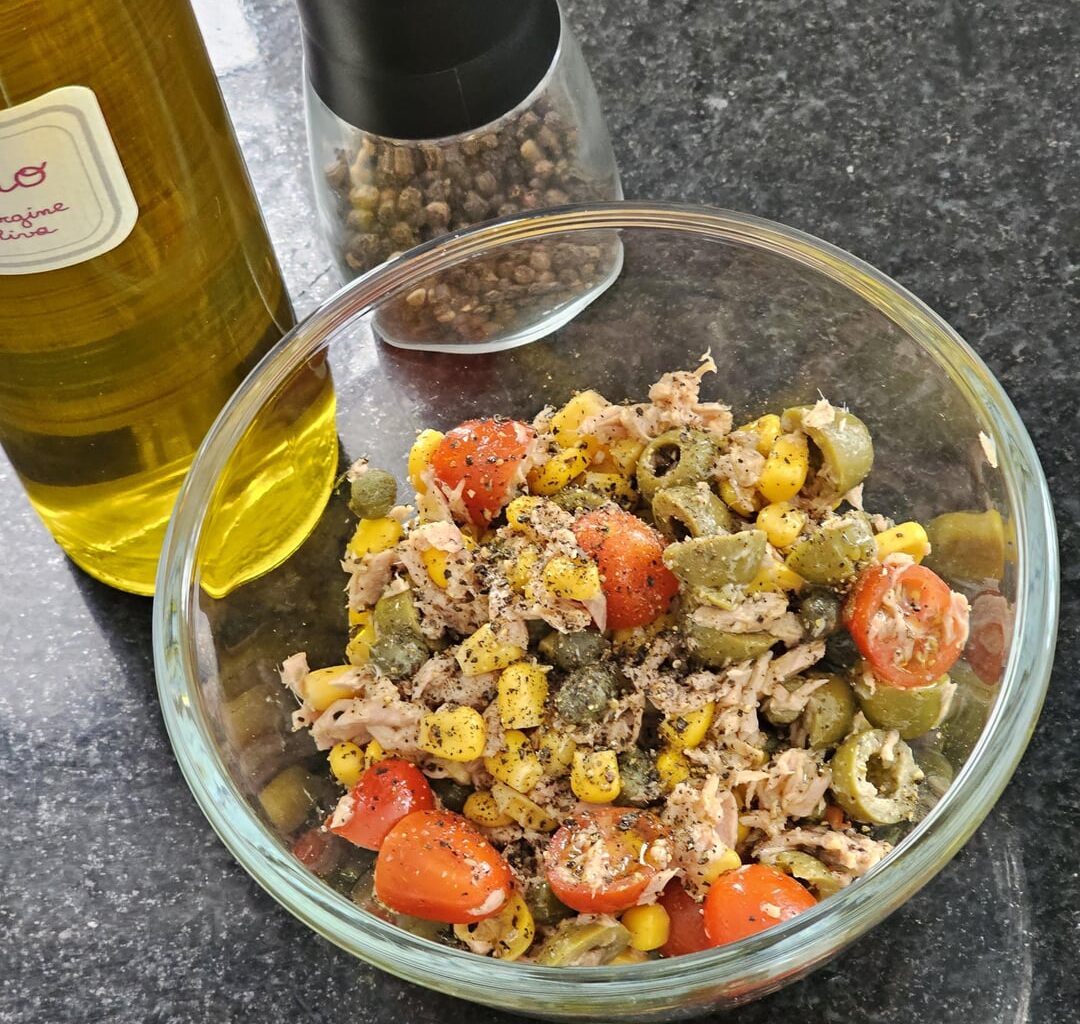 A very hastily composed salad consisting of olives, cherry tomatoes, corn, capers, tuna, an excellent olive oil (still more than ok in spite of the overall sinking quality) and freshly ground black pepper (prep time 5 mins). I love it :)