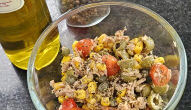 A very hastily composed salad consisting of olives, cherry tomatoes, corn, capers, tuna, an excellent olive oil (still more than ok in spite of the overall sinking quality) and freshly ground black pepper (prep time 5 mins). I love it :)