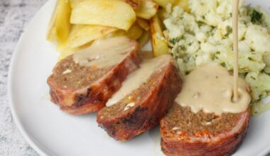 Meatloaf with feta cheese & vegetables wrapped in bacon, served with roast potatoes, cauliflower tossed in herbs and a pepper sauce